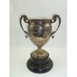 ADIE BROTHERS LTD A TWO-HANDLED SILVER TROPHY CUP, having acanthus leaf and cast dolphin handles,