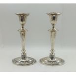 JAMES DIXON AND SONS A PAIR OF EDWARDIAN SILVER CANDLESTICKS of Regency design, having graduated