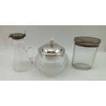 THREE SILVER MOUNTED GLASS ITEMS; an Art Deco conserve jar, the silver cover with Bakelite knop