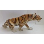 A ROYAL DUX POTTERY STALKING TIGER, polychrome painted, bears factory marks including pink