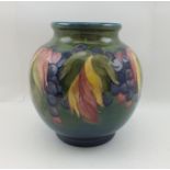 A WILLIAM MOORCROFT POTTERY GLOBULAR VASE in berry and leaf pattern, tube lined and painted on a