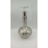 AN ART NOUVEAU GLOBE AND SHAFT DECANTER with floral tendril silver overlaid decoration, fitted