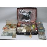 A CASE OF FISHING RELATED ITEMS, includes net, lures, antler priest, etc.