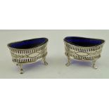 A PAIR OF EDWARDIAN OVAL SILVER SALTS of elliptical form, having pierced and floral decoration,