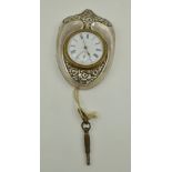 DOUGLAS CLOCK CO. AN EDWARDIAN SILVER CASED DESK CLOCK, having floral embossed shield form case,