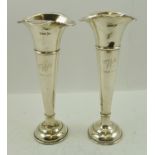 WALKER & HALL A PAIR OF SILVER VASES of trumpet form with fluted, flared rims, on loaded circular