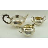 WALKER AND HALL A THREE PIECE SILVER PLATED TEASET of squat form with chased decoration