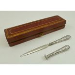 A CASED WHITE METAL PAPER KNIFE AND SEAL, having thistle design to handles in a red and gilt