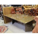 A POLISHED HARDSTONE RECTANGULAR TOPPED COFFEE TABLE with numerous fossil inclusions, supported on a