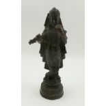 A 19TH CENTURY INDIAN BRONZE STATUE OF KRISHNA, standing pose, robed, holding a flute, on a platform