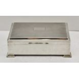 A MID 20TH CENTURY SILVER CIGARETTE BOX, having engine turned hinged cover with cedar lined