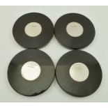 A SET OF FOUR MARBLE COASTERS inset silver discs, 10cm diameter