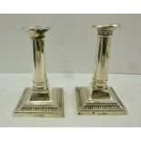 THOMAS BRADBURY & SON A PAIR OF CLASSICAL DESIGN SILVER CANDLESTICKS, having plain tapering stems on