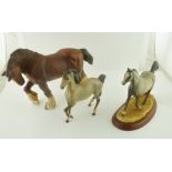 A BESWICK CERAMIC GREY HORSE, 17cm high, together with a pottery SHIRE HORSE, and one other GREY