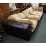 A LARGE MODERNIST MODULAR SOFA of four sections, the chocolate brown leatherette covers and old gold