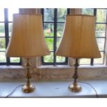 A PAIR OF BRASS TABLE LAMPS each having baluster stem on circular base, with cream shade, overall