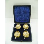 AN SET OF FOUR EDWARDIAN SILVER SALTS, of scallop form with gilded interiors, Sheffield 1904,