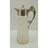 A SILVER MOUNTED CLARET JUG, the top with hinged cover, decorative cast handle, on tapering cut