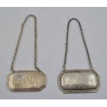 TWO GEORGIAN DESIGN SILVER SPIRIT LABELS, "Brandy" and "Sherry", having canted corners with