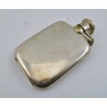 A SILVER PLATED SPIRIT FLASK, having hinged twist cap, in chamois leather outer case, 10cm high