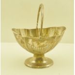 ELKINGTON & CO. A GEORGIAN DESIGN SILVER BON-BON BASKET, with swing handle, fluted body on oval