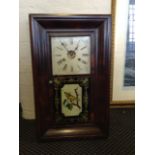 A mahogany American style wall clock with bird design glass panel.