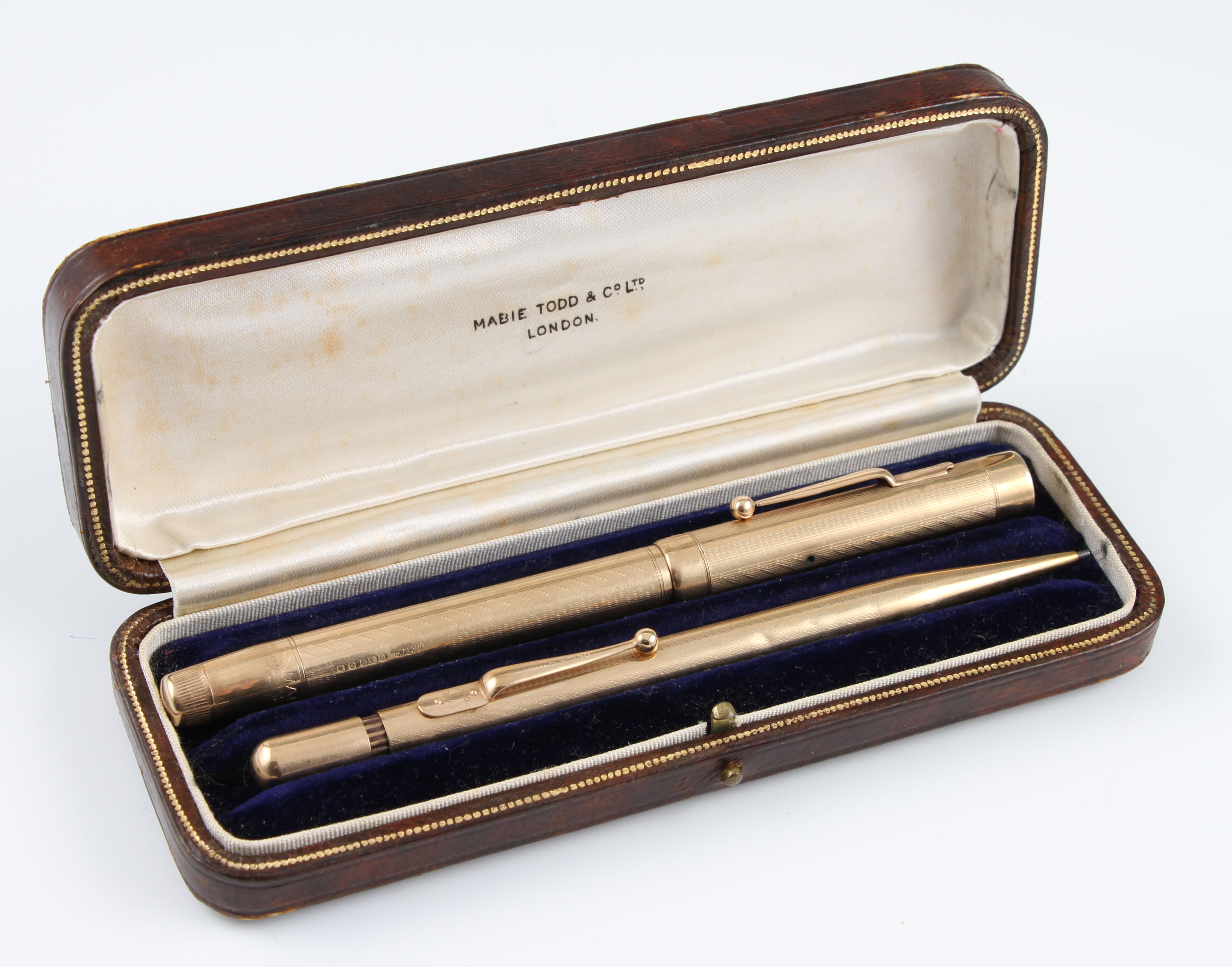 A 9ct yellow gold Swan by Mabie Todd & Co. fountain pen and propelling pencil, engine turned