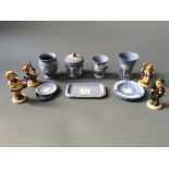 A selection of Wedgwood blue and white items including three vases, one lidded pot, three plates and