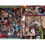 Two boxes of costume jewellery to include bangles, beads, bracelets, earrings etc.