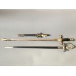 Two ceremonial engraved swords with scabbards, together with a dagger.