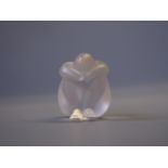 A Lalique frosted glass female figurine, seated cross-legged with arms covering her face.