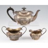A matched early 20th Century silver tea set, comprising a teapot, sugar bowl and milk jug, teapot