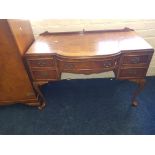 A walnut three piece bedroom suite, two door wardrobe and a dressing table and headboard.