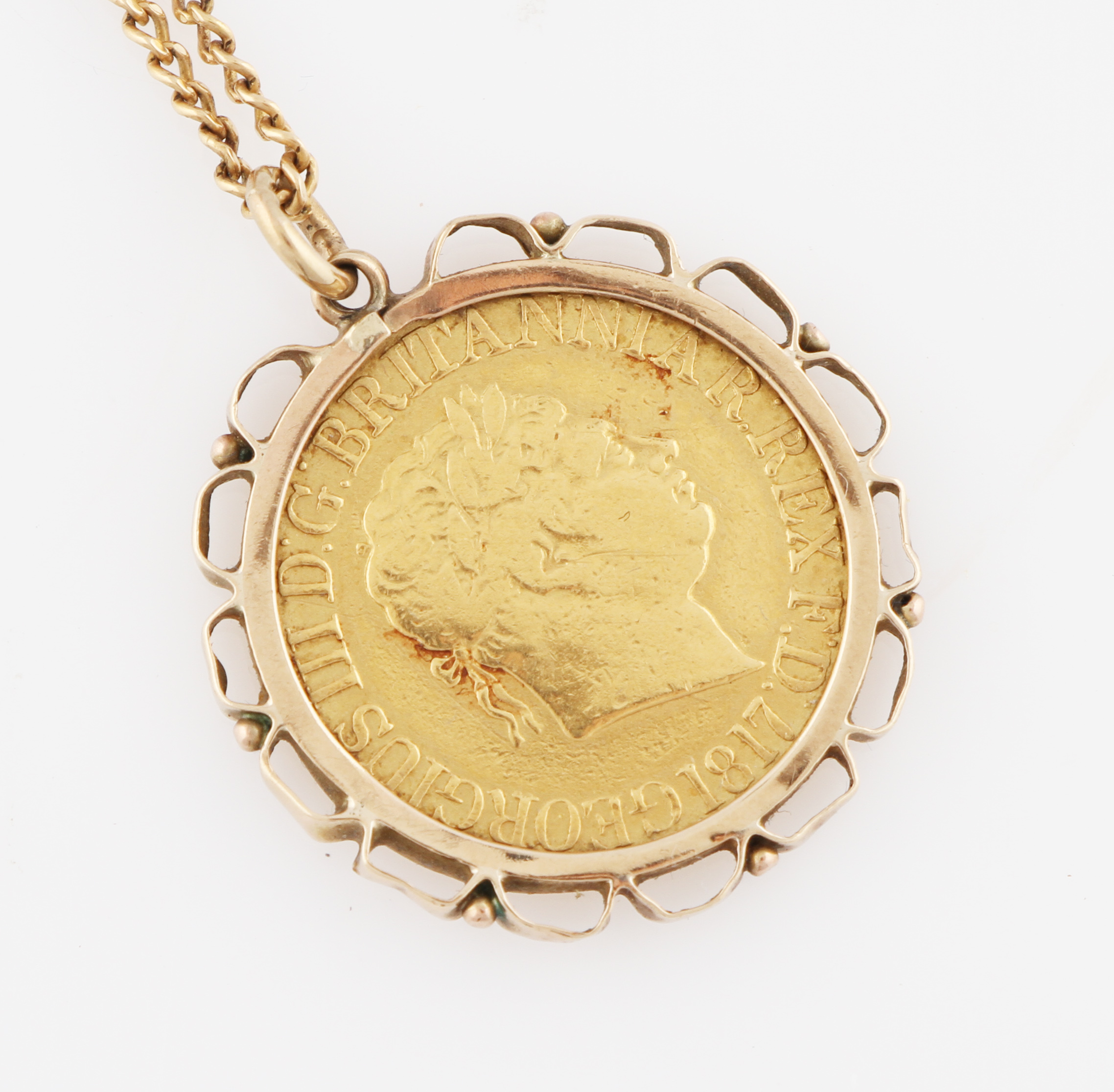 A George III 1817 full sovereign, in pendant mount on yellow metal curb link chain.