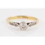 A diamond ring, set with a central transition cut diamond, measuring approx. 0.35ct, flanked to