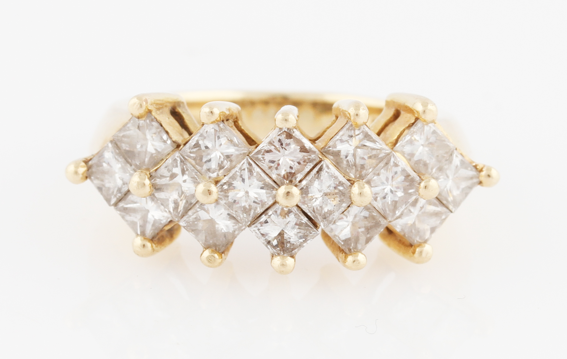 A diamond dress ring, set with sixteen princess cut diamonds, in geometric pattern, each measuring