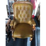 An Edwardian leather upholstered, button back chair.