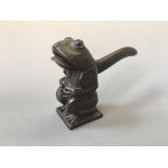 A Black Forest oak nutcracker in the shape of a toad.