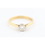 An 18ct yellow gold diamond solitaire ring, set with a round brilliant cut diamond, measuring