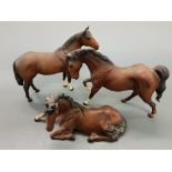 Three Beswick ceramic horses, ( two standing, one lying down).