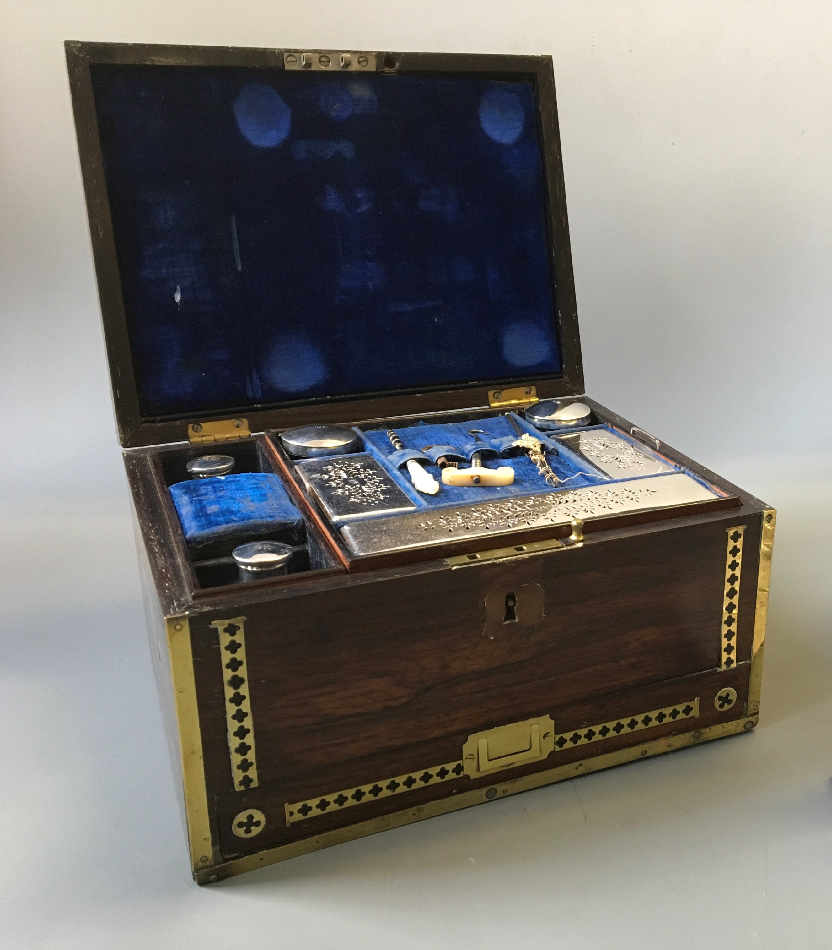 A brass cased vanity box with blue velvet interior, marked MEC.