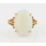 An opal ring, set with an oval opal cabochon, measuring approx. 16x11mm, to a split shoulder