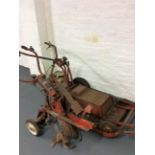 A Wolseley major cultivator together with a Briggs & Stratton lawnmower.