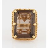 A smoky quartz dress ring, set with a rectangular cut smoky quartz, with open metalwork gallery,