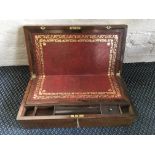 *A rosewood writing slope with red leather interior and exterior brass details.