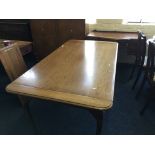 An oak reproduction extended dining table with two spare leaves.