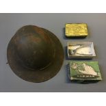 A soldiers helmet with Princess Mary Christmas 1914 gift tin and Burman hair clipper.