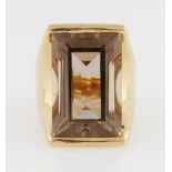 An 18ct yellow gold smoky quartz dress ring, set with a rectangular cut smoky quartz, hallmarked