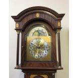A James Stewart Armagh reproduction mahogany grandfather clock with column and inlay design.
