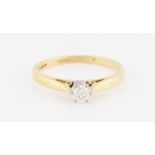 An 18ct yellow gold diamond solitaire ring, set with a round brilliant cut diamond, measuring